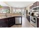 Well-lit kitchen features stainless steel appliances and wood-look flooring at 767 Omaha Dr, Broadway, NC 27505