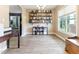 Bright living room features hardwood floors, built in book shelves, and a large window at 767 Omaha Dr, Broadway, NC 27505