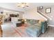 Open concept living room with wood-look floors and a large sectional couch at 767 Omaha Dr, Broadway, NC 27505