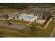 Aerial view of community pool with waterslides, splash pad, playground, and surrounding clubhouse at 8 Pin Tail Ct, Pittsboro, NC 27312