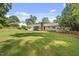 Beautiful home with large, lush backyard featuring mature trees and an inviting outdoor area at 821 Van Thomas Dr, Raleigh, NC 27615