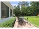 Inviting backyard patio area perfect for outdoor dining and entertaining with mature landscape at 821 Van Thomas Dr, Raleigh, NC 27615