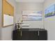 Interior bar area features dark wood cabinets with brass hardware and coastal-themed artwork at 821 Van Thomas Dr, Raleigh, NC 27615