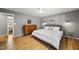Spacious bedroom featuring hardwood floors, modern lighting, and comfortable furnishings at 821 Van Thomas Dr, Raleigh, NC 27615