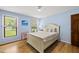 Bright bedroom with hardwood floors and natural light from two windows, and classic decor at 821 Van Thomas Dr, Raleigh, NC 27615