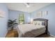 Charming bedroom featuring a ceiling fan, wood floors, and bright natural light at 821 Van Thomas Dr, Raleigh, NC 27615