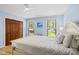 Comfortable bedroom featuring wood floors, ceiling fan, natural light, and spacious closet at 821 Van Thomas Dr, Raleigh, NC 27615
