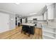 Bright eat-in kitchen features white cabinets, granite countertops, and central island with barstool seating at 821 Van Thomas Dr, Raleigh, NC 27615