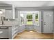 Cozy breakfast nook features bay window with backyard view, wood floors, and exterior door at 821 Van Thomas Dr, Raleigh, NC 27615