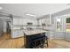 Well-equipped kitchen with white cabinets, granite countertops, central island, and modern stainless steel appliances at 821 Van Thomas Dr, Raleigh, NC 27615