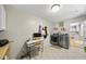 Convenient laundry area with modern washer and dryer, built-in storage and adjacent desk at 821 Van Thomas Dr, Raleigh, NC 27615