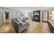Open-concept living room with fireplace, ceiling fan, wood floors, and neutral color palette at 821 Van Thomas Dr, Raleigh, NC 27615