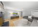 Cozy living room featuring brick fireplace, hardwood floors, ceiling fan, and stylish decor at 821 Van Thomas Dr, Raleigh, NC 27615