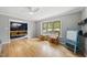 Open-concept living room with hardwood floors and bright windows, seamlessly flowing into the dining area at 821 Van Thomas Dr, Raleigh, NC 27615