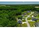 Beautiful aerial view of new construction homes surrounded by lush green trees in a modern planned community at 8341 Running Fern Way, Willow Springs, NC 27592