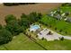 An aerial captures a beautiful community pool with a sun deck, lounge chairs, and mature landscaping in the common area at 8341 Running Fern Way, Willow Springs, NC 27592