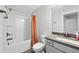 Bright bathroom featuring a shower-tub combo, bronze fixtures, a granite countertop, and a white sink at 8341 Running Fern Way, Willow Springs, NC 27592