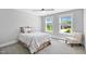 Cozy bedroom with plush bedding, neutral tones, and natural light streaming through the windows at 8341 Running Fern Way, Willow Springs, NC 27592