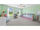 Bright bedroom with mint walls, plush pink couch and chair, and plenty of natural light at 8341 Running Fern Way, Willow Springs, NC 27592