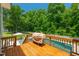 Inviting wooden deck area overlooking the sparkling pool and a lush green backyard surrounded by mature trees at 8341 Running Fern Way, Willow Springs, NC 27592