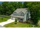 Beautiful exterior elevation featuring lush lawns, beautiful trees, and a well-maintained driveway at 8341 Running Fern Way, Willow Springs, NC 27592