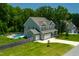 Beautiful two-story home featuring a swimming pool, well-manicured lawn, and an attached two-car garage at 8341 Running Fern Way, Willow Springs, NC 27592