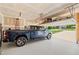 Spacious three-car garage with epoxy flooring and storage racks, perfect for car enthusiasts at 8341 Running Fern Way, Willow Springs, NC 27592