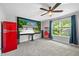 Home theater featuring large screen, blue curtains, a red refrigerator, and a vintage popcorn machine at 8341 Running Fern Way, Willow Springs, NC 27592