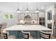 Bright kitchen with a large island, stainless steel appliances, and ample counter space at 8341 Running Fern Way, Willow Springs, NC 27592