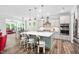 Open-concept kitchen and dining area featuring a large island with seating and stainless steel appliances at 8341 Running Fern Way, Willow Springs, NC 27592