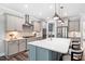 Spacious kitchen with a large island, stainless steel appliances, and pendant lighting at 8341 Running Fern Way, Willow Springs, NC 27592