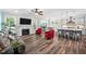 Open living room with a fireplace, TV, and views of the kitchen and dining area at 8341 Running Fern Way, Willow Springs, NC 27592