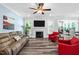 Bright living room showcasing the fireplace and TV at 8341 Running Fern Way, Willow Springs, NC 27592