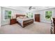 Spacious main bedroom with large windows, soft carpet, and a decorative ceiling fan at 8341 Running Fern Way, Willow Springs, NC 27592