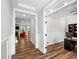 An office area with wood flooring, access to a living area, and modern decor at 8341 Running Fern Way, Willow Springs, NC 27592