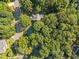Aerial view of a home nestled among lush green trees at 8412 Old Deer Trl, Raleigh, NC 27615