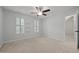 Bright bedroom with neutral carpet, light gray walls, white trim, and a ceiling fan at 8412 Old Deer Trl, Raleigh, NC 27615