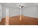 Large bedroom with hardwood floors, neutral walls, ceiling fan and two closets; perfect for storage at 8412 Old Deer Trl, Raleigh, NC 27615