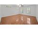 Expansive bedroom featuring hardwood floors, white walls, and large windows for abundant natural light at 8412 Old Deer Trl, Raleigh, NC 27615