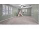 Spacious bedroom with neutral carpet and light green walls, enhanced by a ceiling fan and ample natural light at 8412 Old Deer Trl, Raleigh, NC 27615