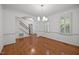 Dining room featuring hardwood floors, natural light, and elegant crown molding at 8412 Old Deer Trl, Raleigh, NC 27615