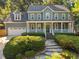 Charming home featuring stone walkway, manicured bushes, and a welcoming porch at 8412 Old Deer Trl, Raleigh, NC 27615