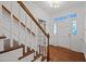 Foyer area with hardwood floors and an elegant staircase at 8412 Old Deer Trl, Raleigh, NC 27615