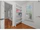 Hallway with a built-in bookcase and shuttered window provides natural light at 8412 Old Deer Trl, Raleigh, NC 27615