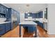 Bright kitchen with island, hardwood floors, and stainless steel appliances at 8412 Old Deer Trl, Raleigh, NC 27615
