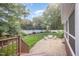 Manicured backyard features a stone patio with outdoor seating surrounded by greenery, offering a serene and private setting at 9021 Winged Thistle Ct, Raleigh, NC 27617