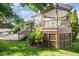 Charming backyard boasts a deck, patio, and pergola, all nestled in a lush green lawn, perfect for outdoor enjoyment at 9021 Winged Thistle Ct, Raleigh, NC 27617
