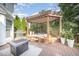 Backyard deck featuring hot tub, fire pit, and grilling area at 9021 Winged Thistle Ct, Raleigh, NC 27617