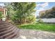 Landscaped backyard with stairs, brick patio, and lawn at 9021 Winged Thistle Ct, Raleigh, NC 27617