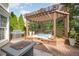 Backyard deck featuring hot tub, fire pit, and grilling area at 9021 Winged Thistle Ct, Raleigh, NC 27617